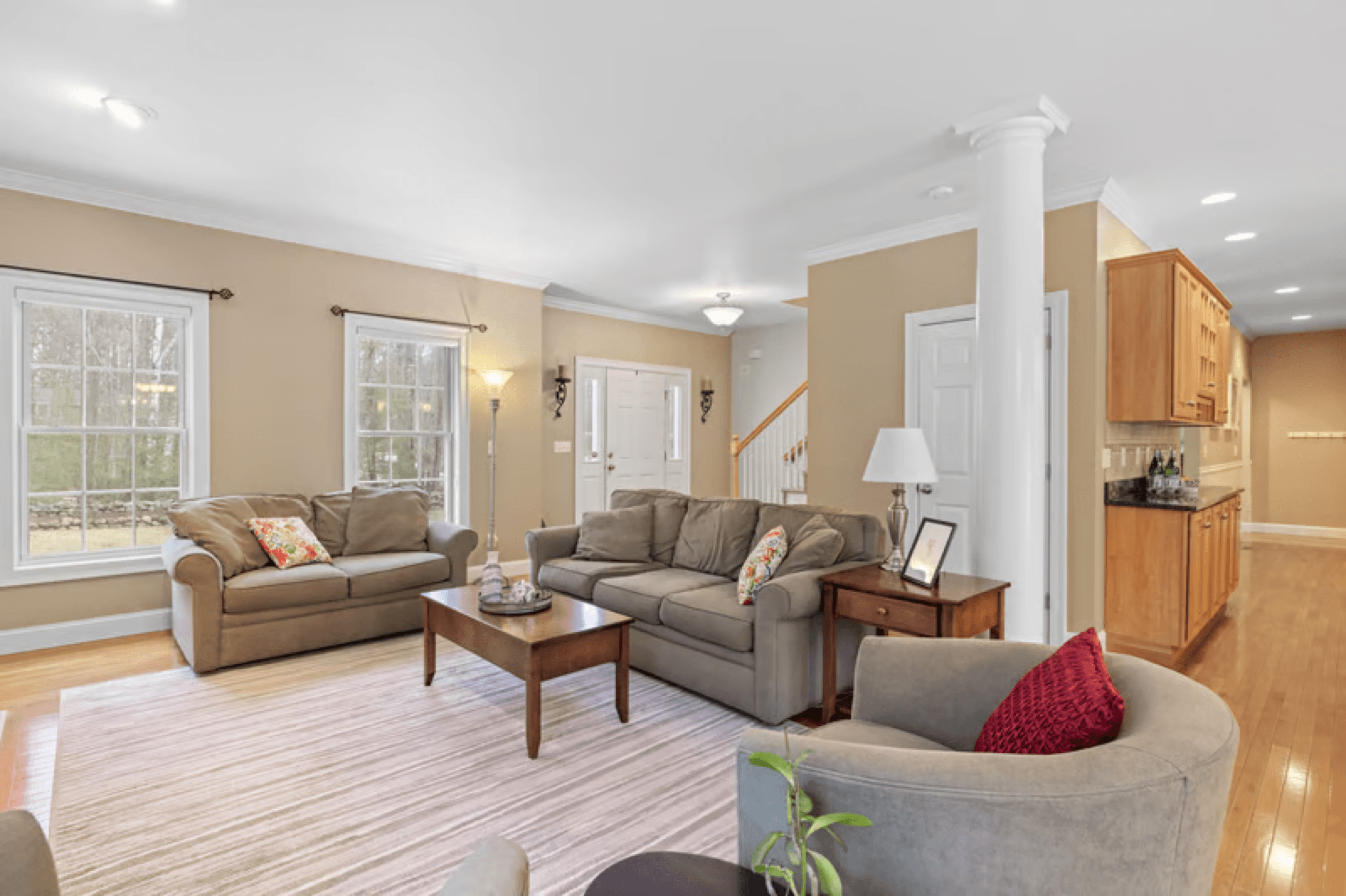 Sunlit living room with fresh, tidy furniture and clean floors
