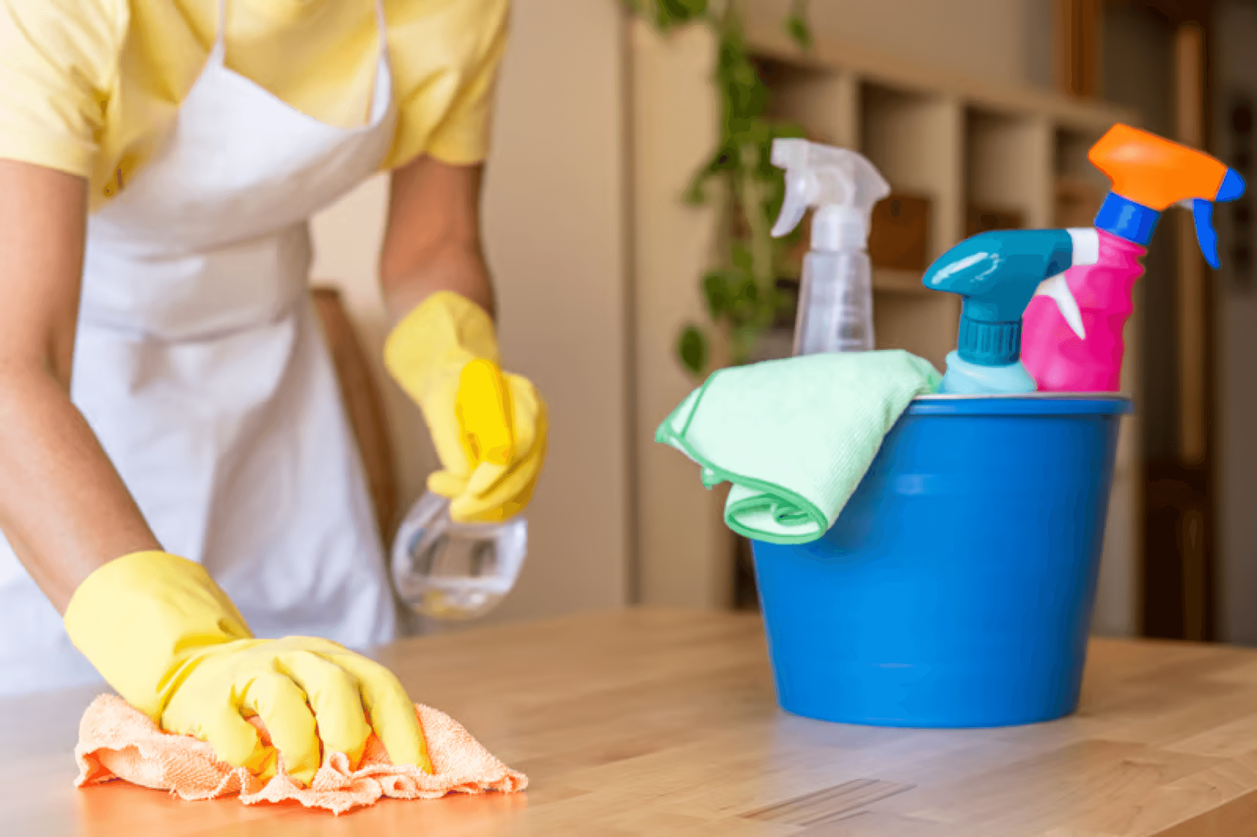 Cleaning caddy with supplies and a fresh apron, ready for a house cleaning visit