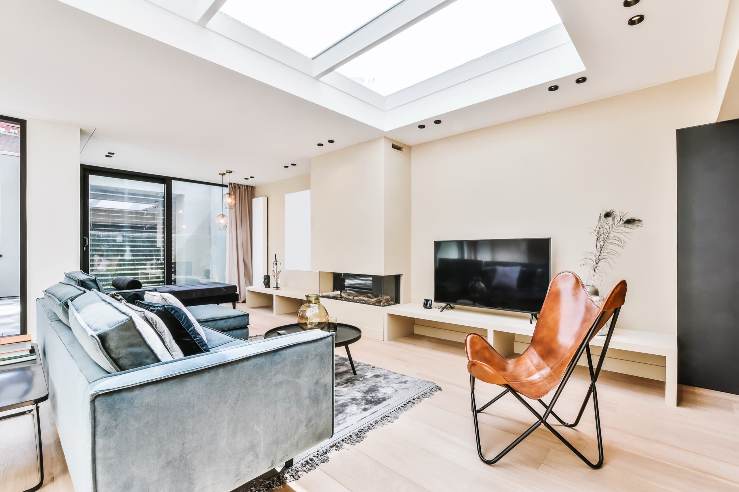 Bright, freshly cleaned living room with natural light from a skylight