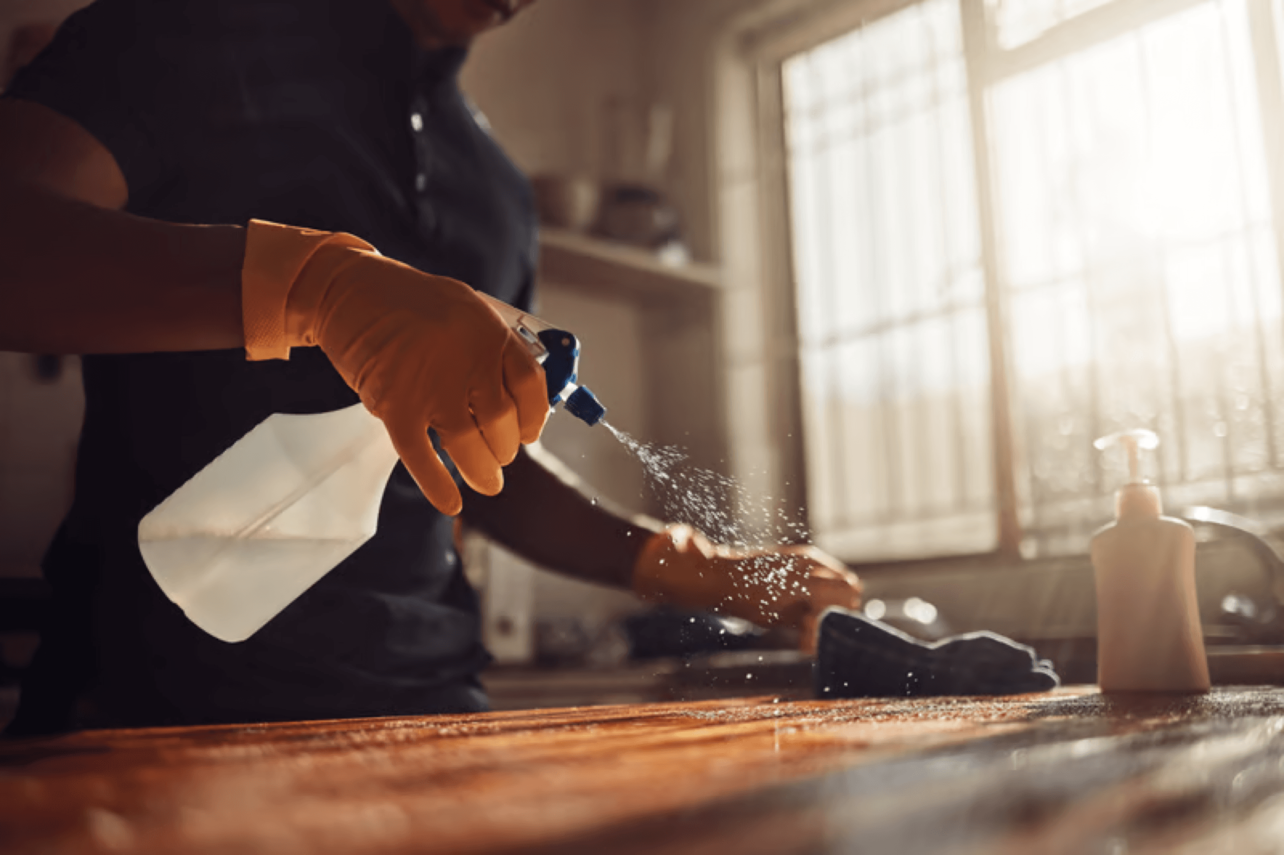 Hands wiping a surface to a spotless finish