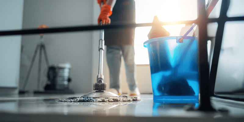 Mop and bucket on a hard floor during an office cleaning